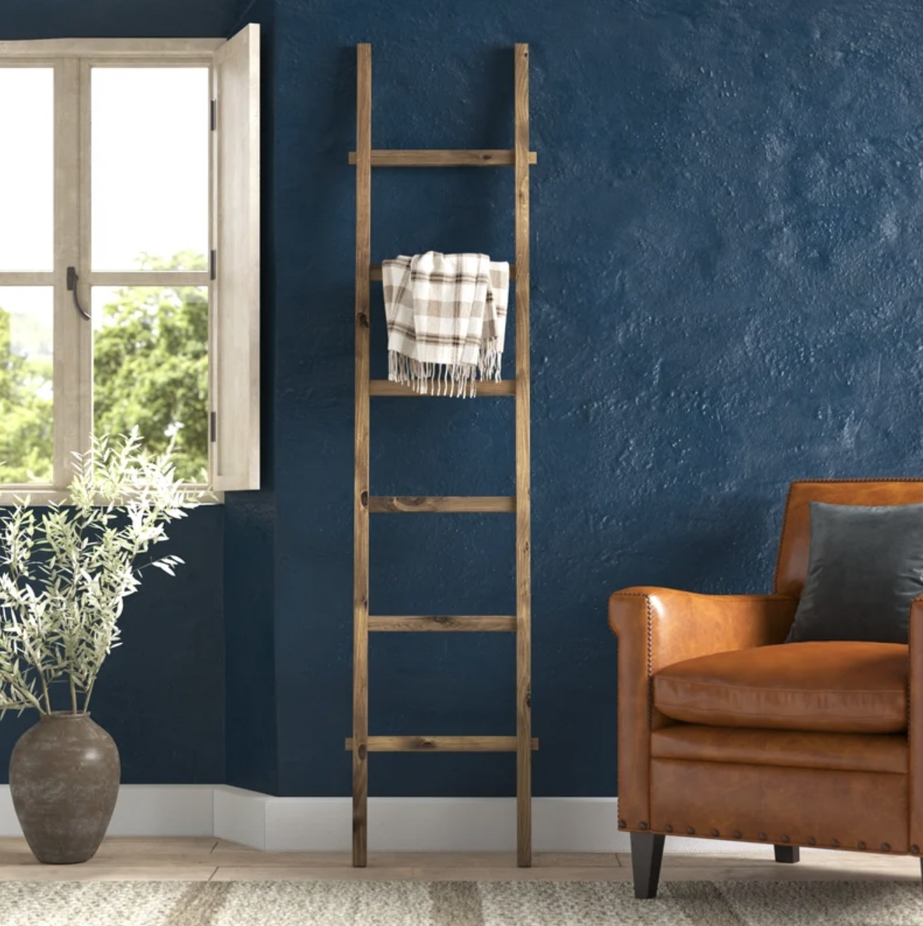 wooden ladder with blanket hanging on it