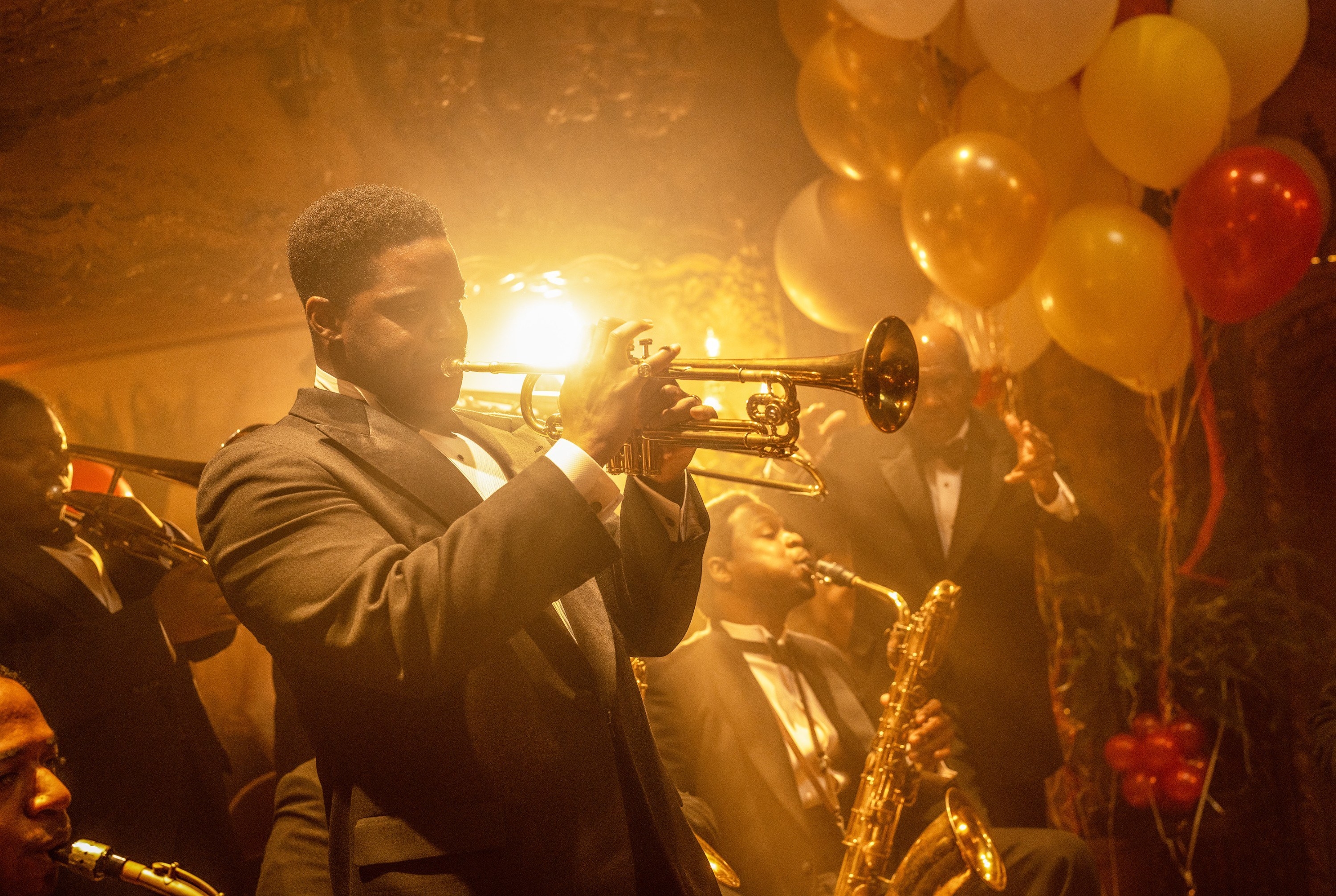 Sidney playing trumpet at a decadent party