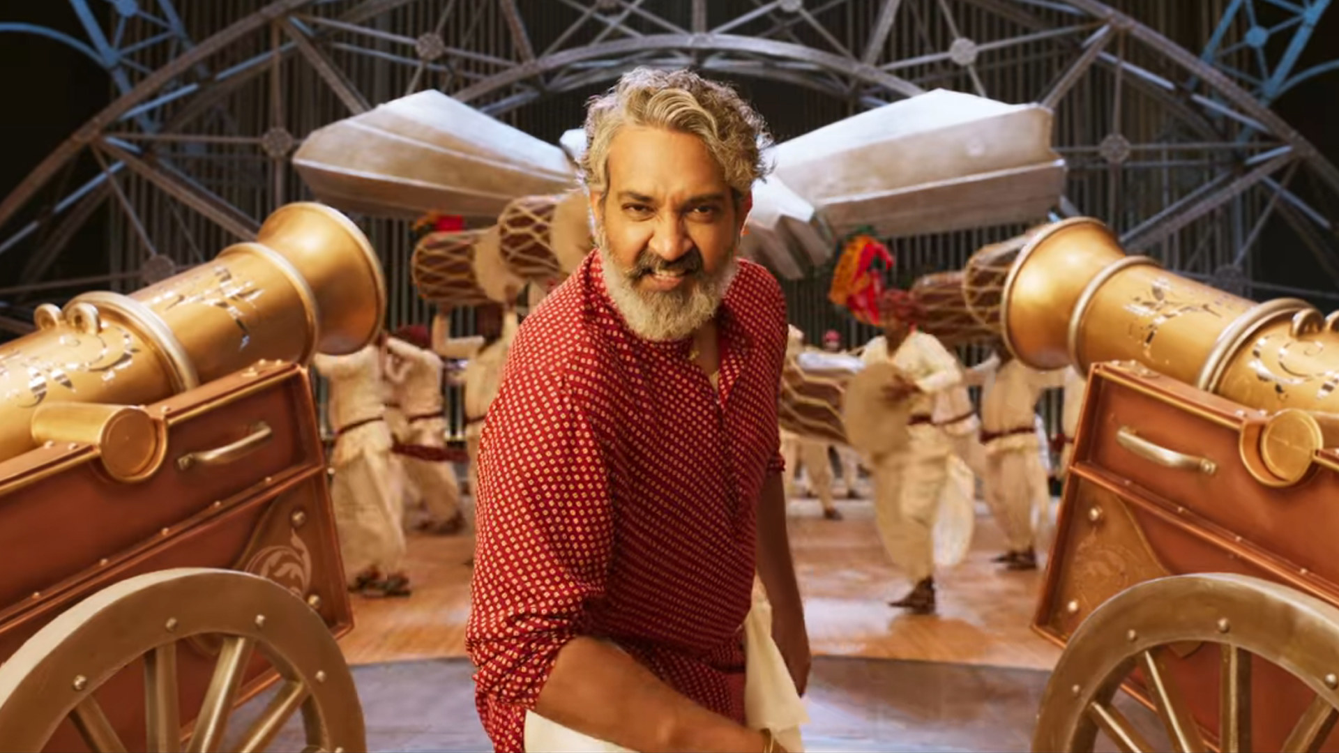 S.S. Rajamouli stands between two gold canons