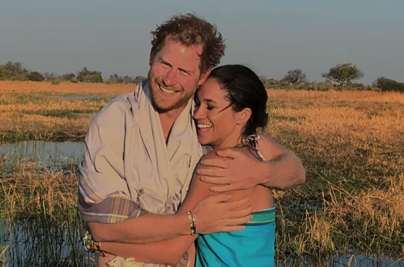 prince harry and meghan markle hugging in a field