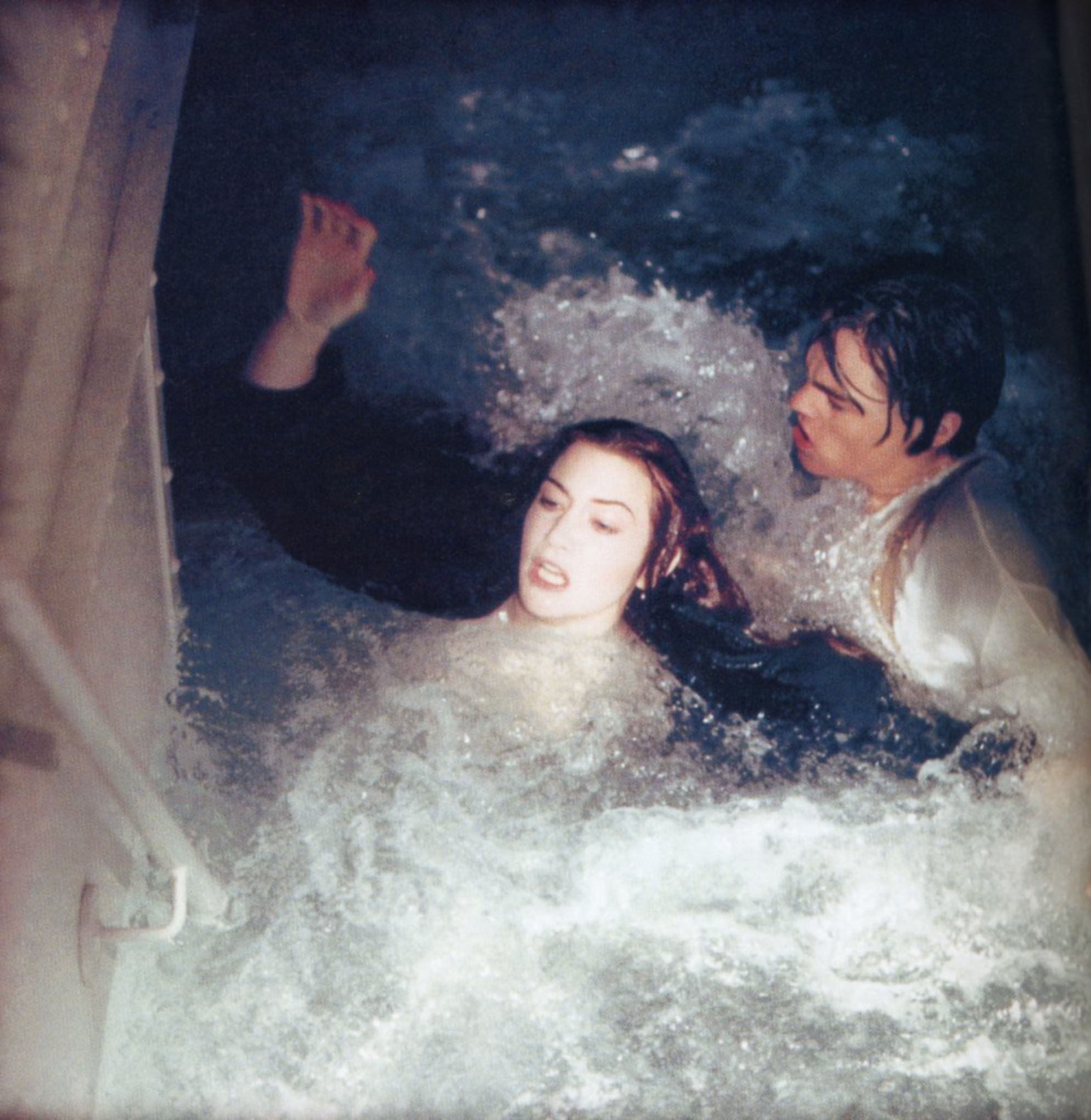 Winslet and DiCaprio struggling in water during a flooding scene