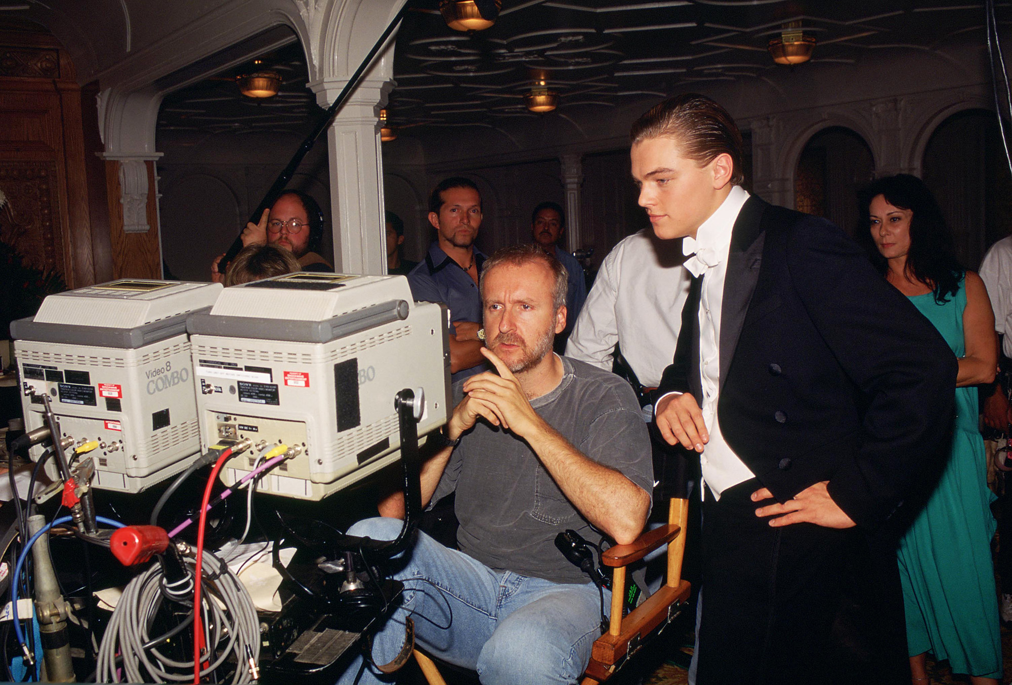 Cameron and DiCaprio reviewing footage, while DiCaprio is in a tux 