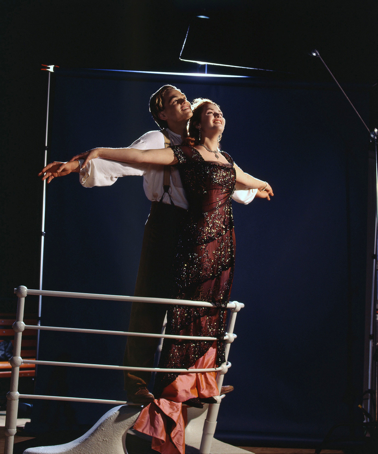 DiCaprio and Winslet with their arms outstretched on the edge of the ship during the famous &quot;I&#x27;m flying&quot; scene