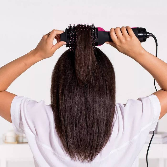 a model using the hair dryer brush