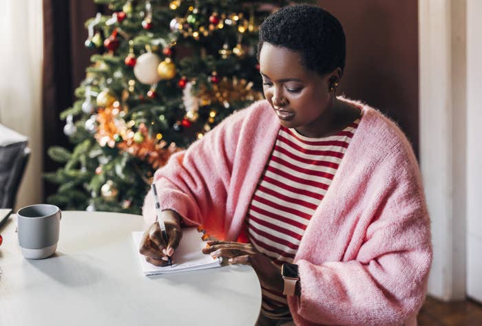 Afro-American woman writing her plan for a New Year on a Christmas day