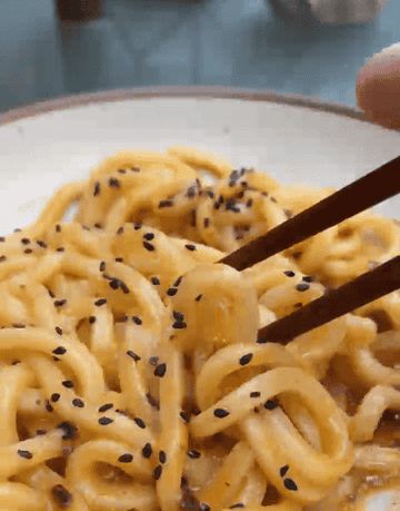 gif of saucy udon noodles in bowl