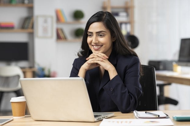 young woman in office working on laptop