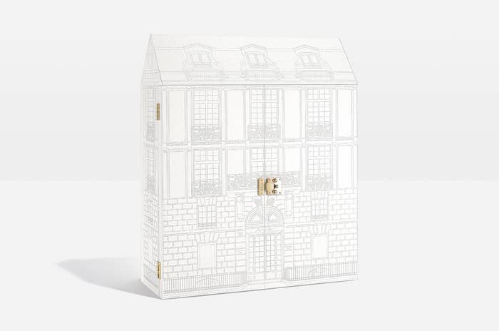 A large box designed to look like a building while it&#x27;s closed, with a latch on the front to open it and reveal the advent calendar inside