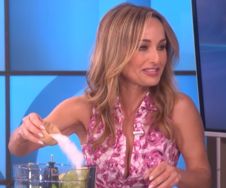 Giadda pouring in a huge amount of salt into a blender
