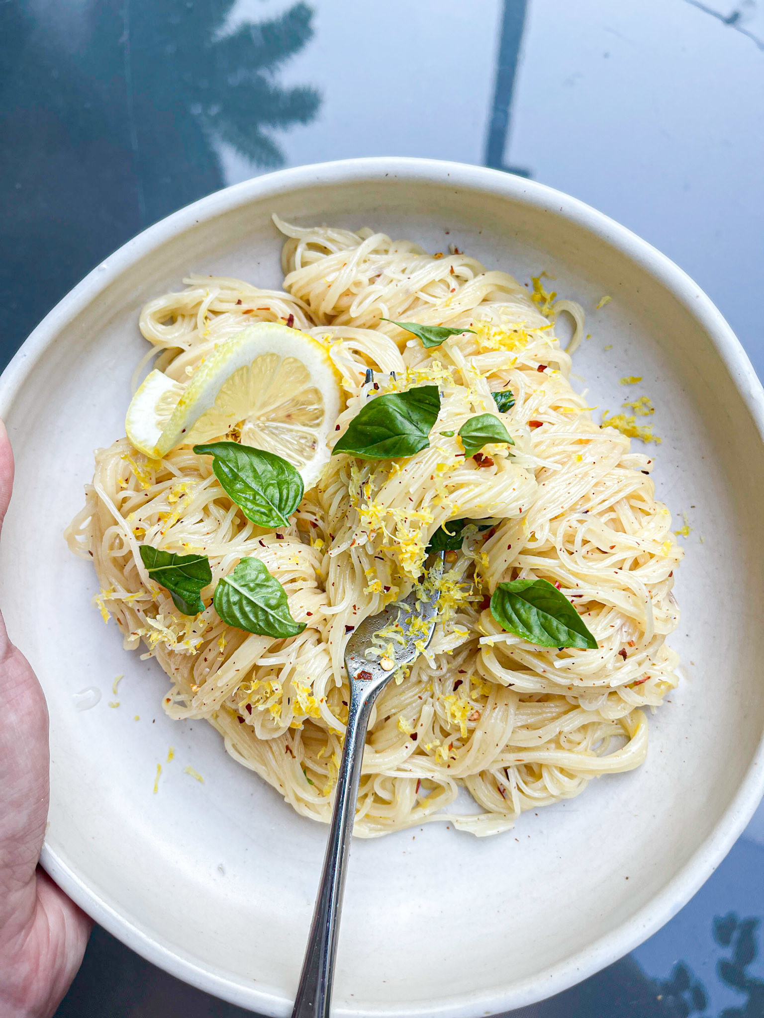 lemon spaghetti with basil and lemon on plate