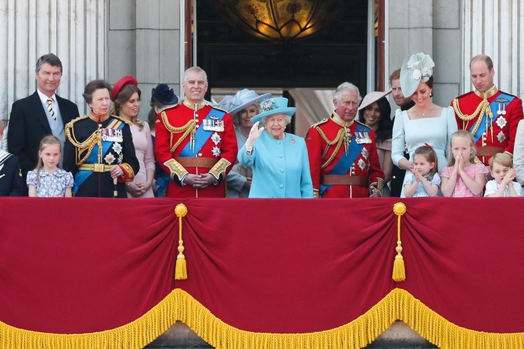 The royal family standing on a balcony