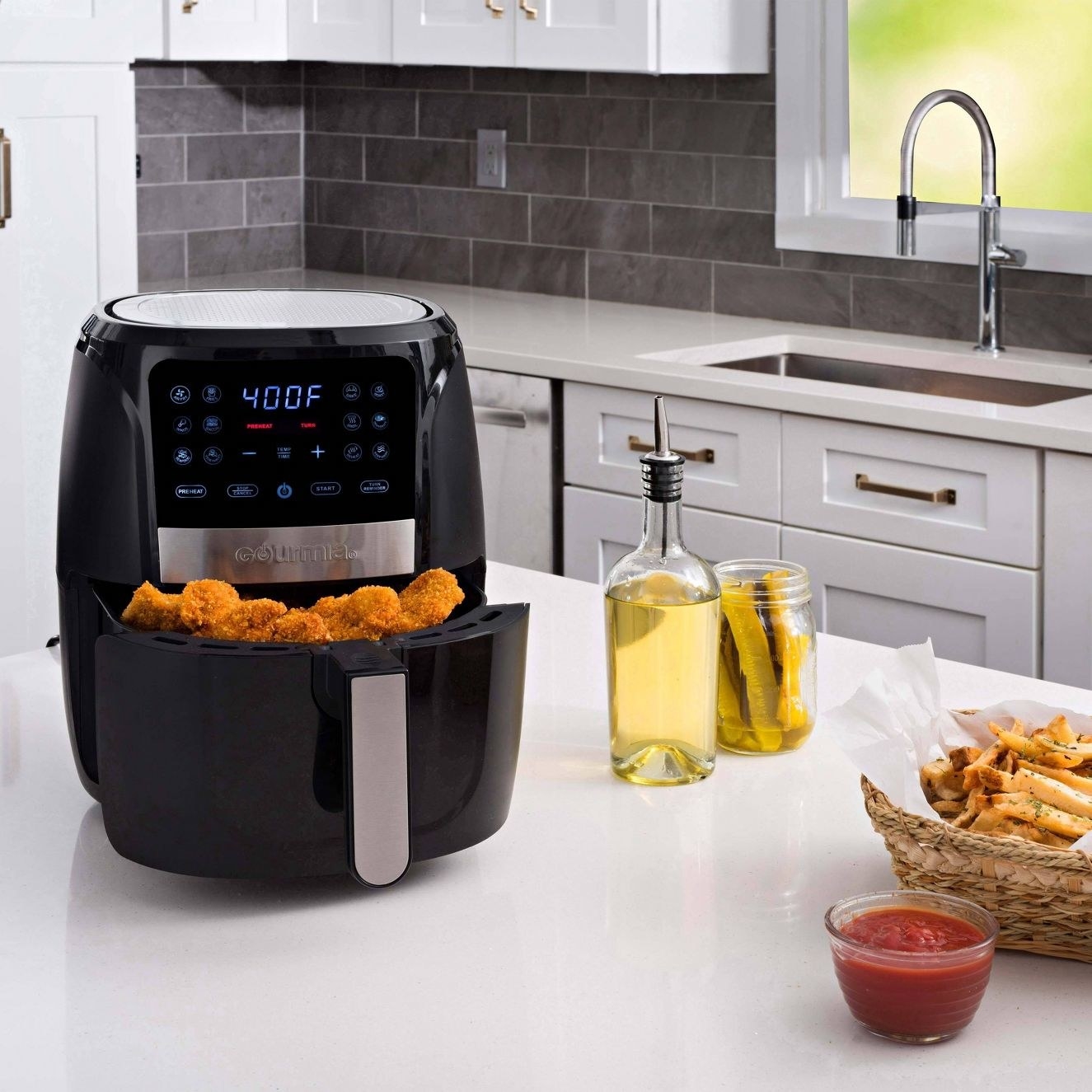 the air fryer on a counter with food in the basket