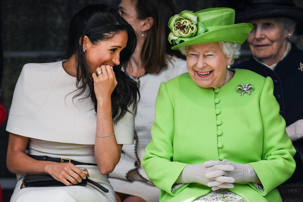 Meghan and the Queen sitting and smiling