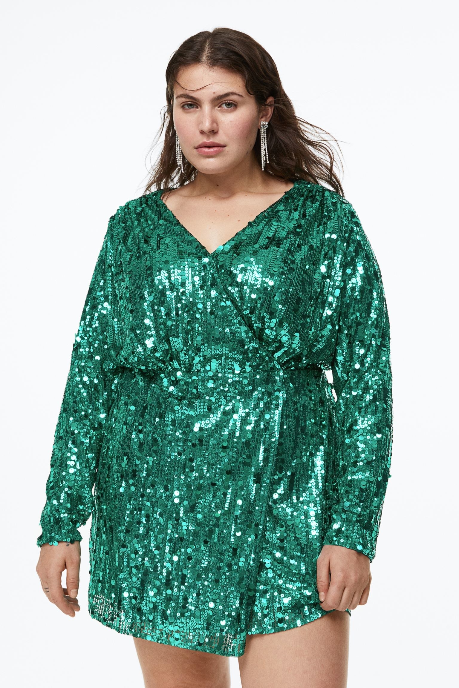 a model wearing the green sequin dress