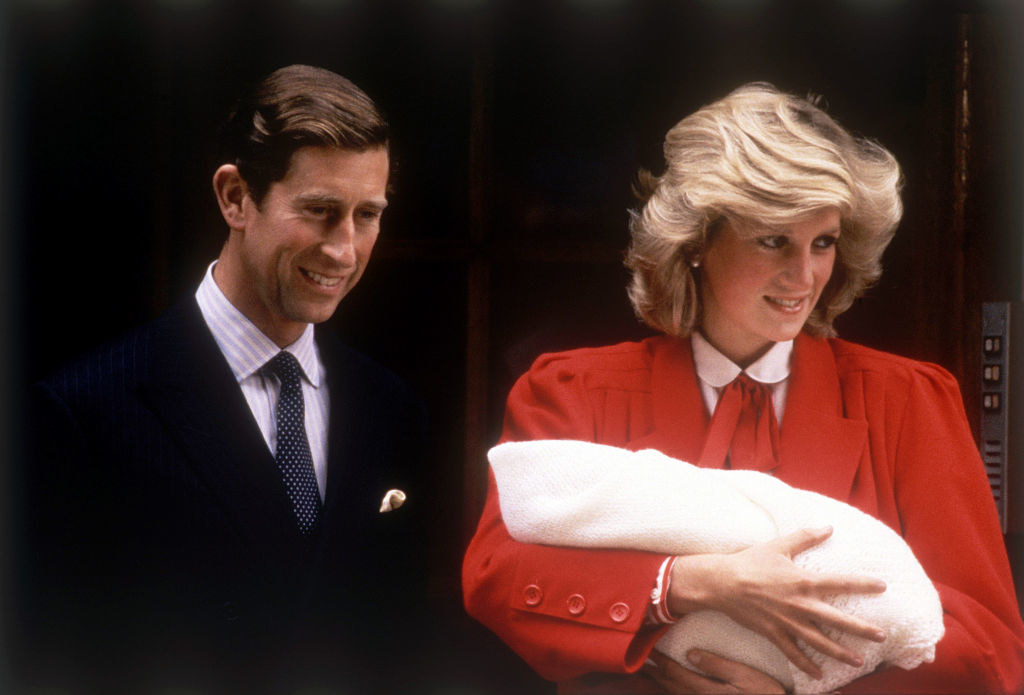 Prince Charles with Diana, who is holding a baby
