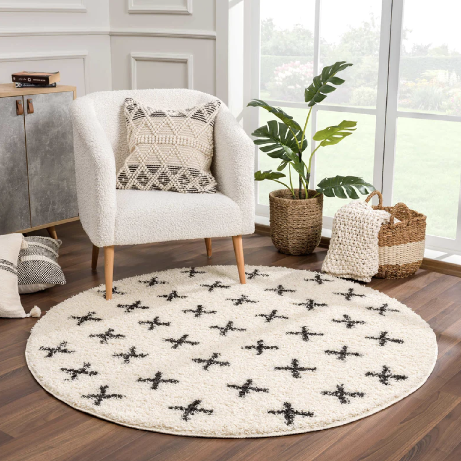 Round white textured rug and black plus sign pattern throughout