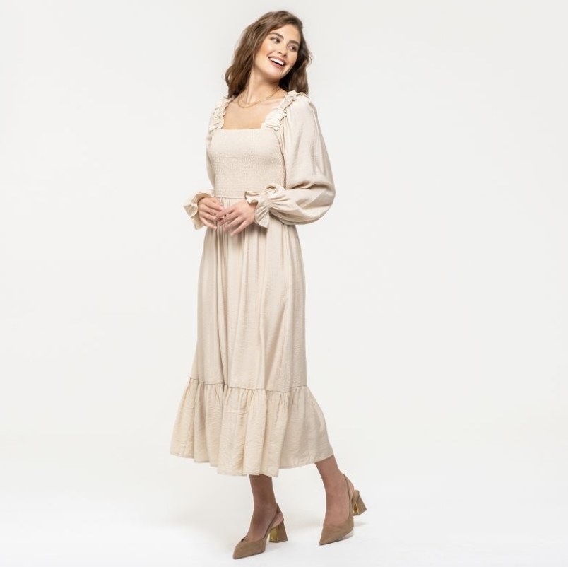 The model wears the long ruched dress in khaki