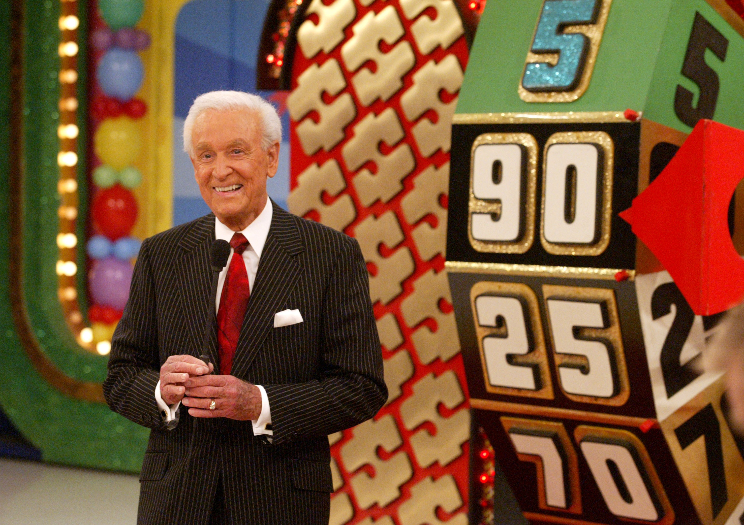 Bob Barker standing near the wheel with his microphone on &quot;The Price Is Right&quot;
