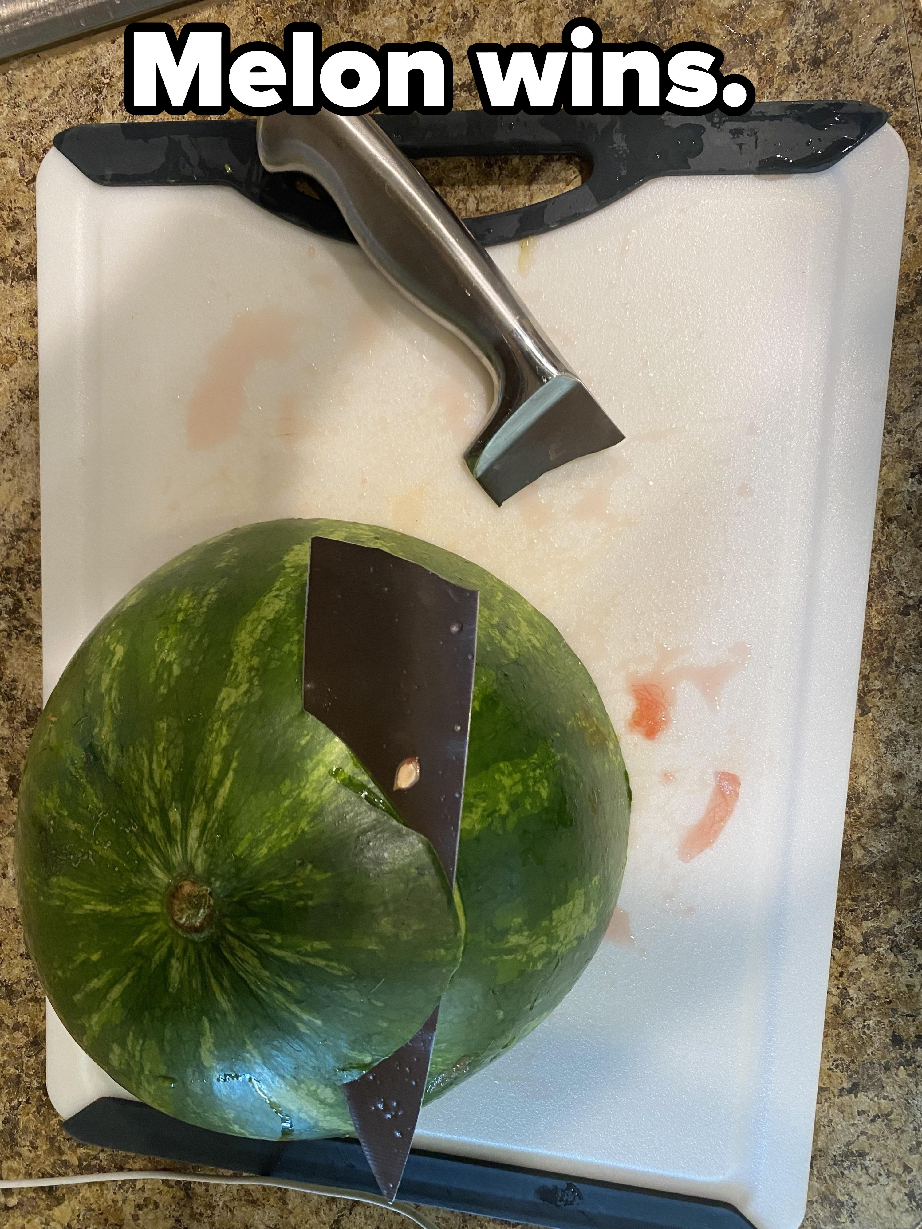 A broken knife in a watermelon