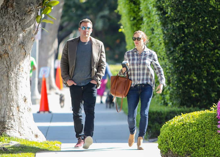 Ben and Jennifer dressed casually and walking on the street