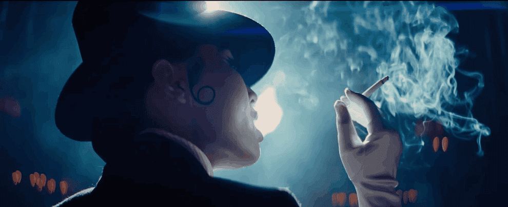 Movie gif: Li Jun Li wearing a top hat and smoking