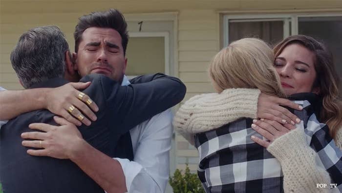 the family of "schitt's creek" hug each other