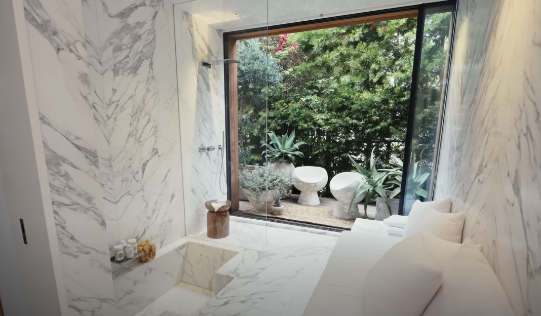 white marble bathroom with sliding doors to outside