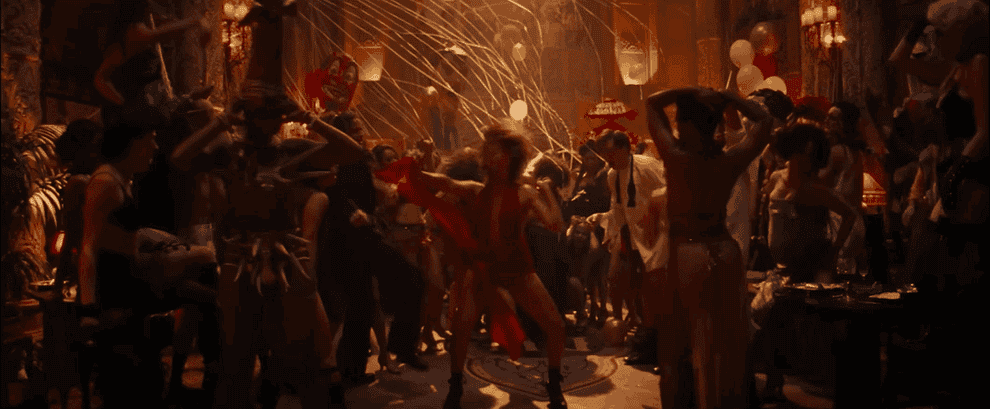 Movie gif: Margot Robbie dancing in a crowd while wearing a scarf-like dress
