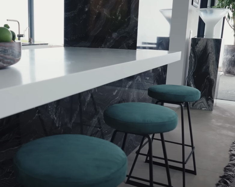 three green velvet stools next to the kitchen