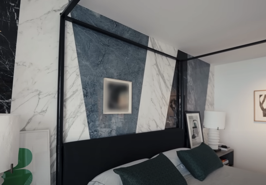 white, blue, and black marble geometric pattern next to bed