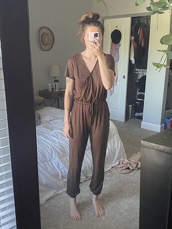reviewer photo of them wearing a brown short sleeve jumpsuit