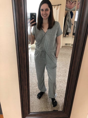 reviewer photo of them wearing a gray short sleeve jumpsuit