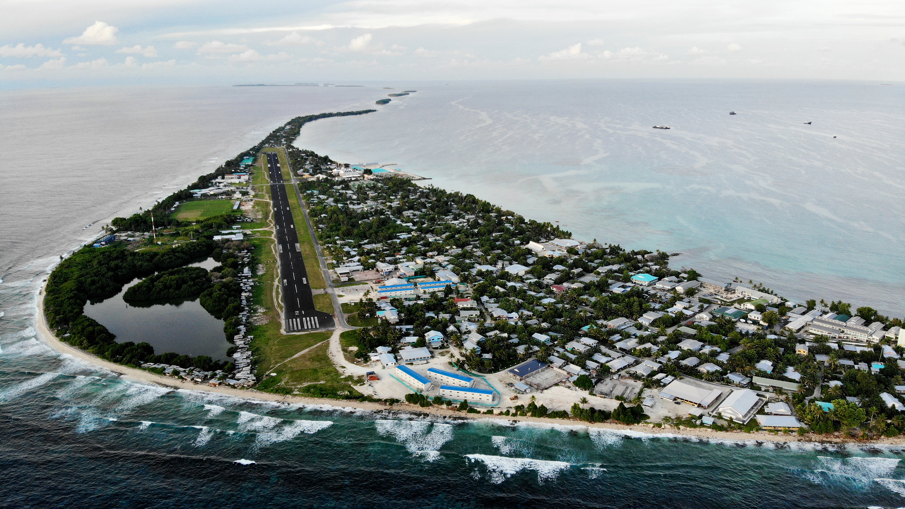 An aerial view of downtown and the airport runway, between the Pacific Ocean and lagoon in Funafuti, Tuvalu
