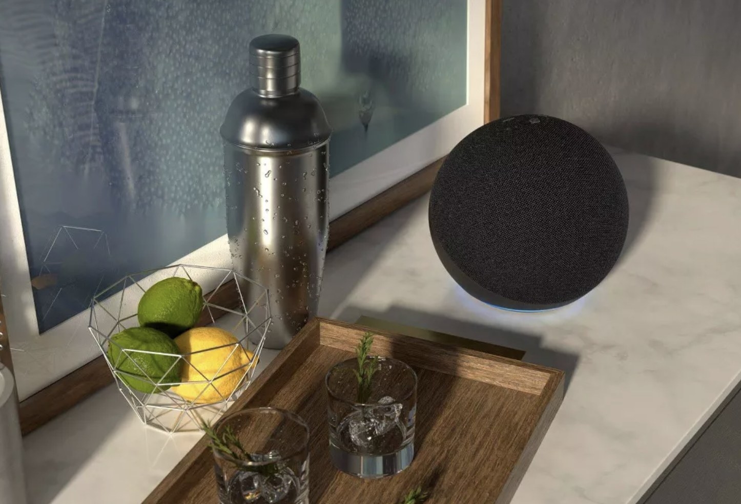 the black Echo speaker on counter next to kitchen serving tray with drinks and bowl of lemons and limes