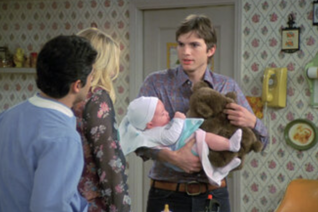 Kelso holding a baby
