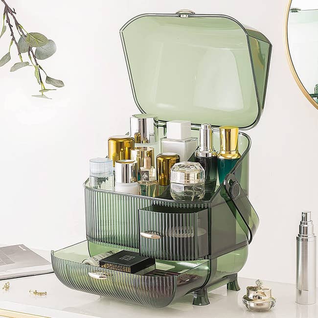 the green makeup organizer with drawers open and cover off