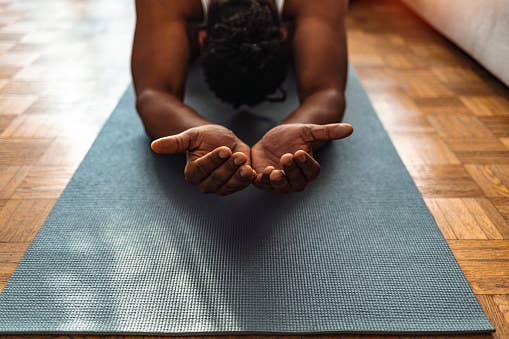 man meditating on a mat