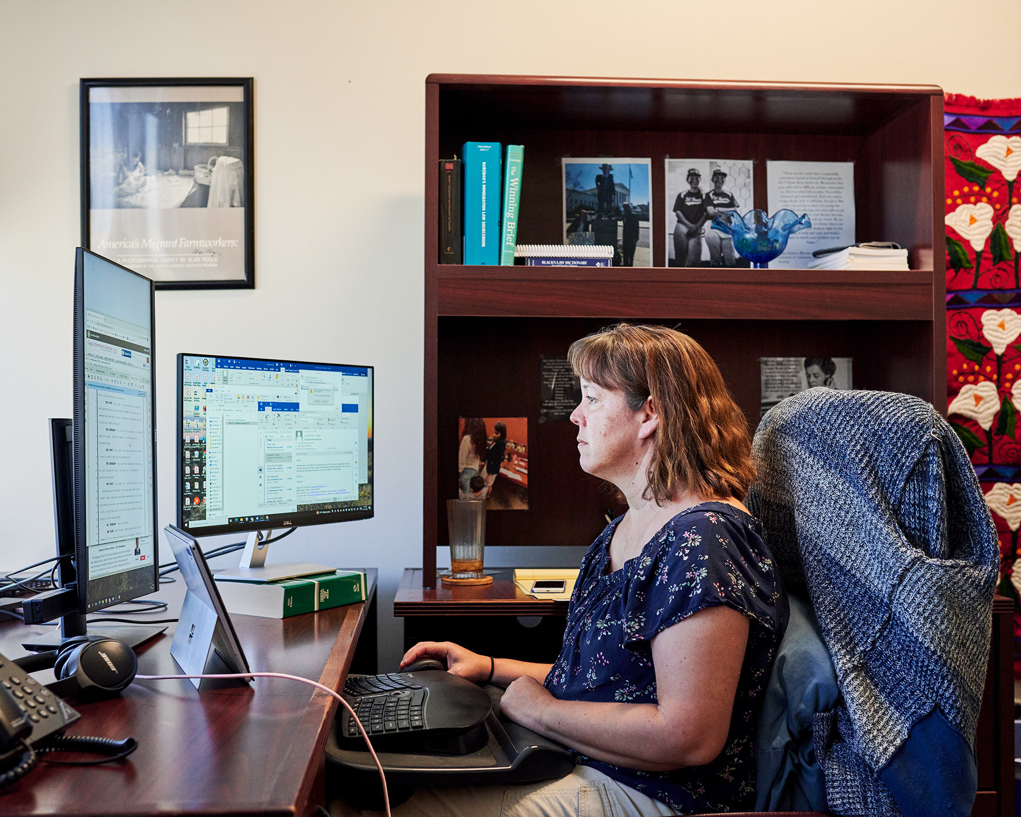 A woman at a desk working on a computer