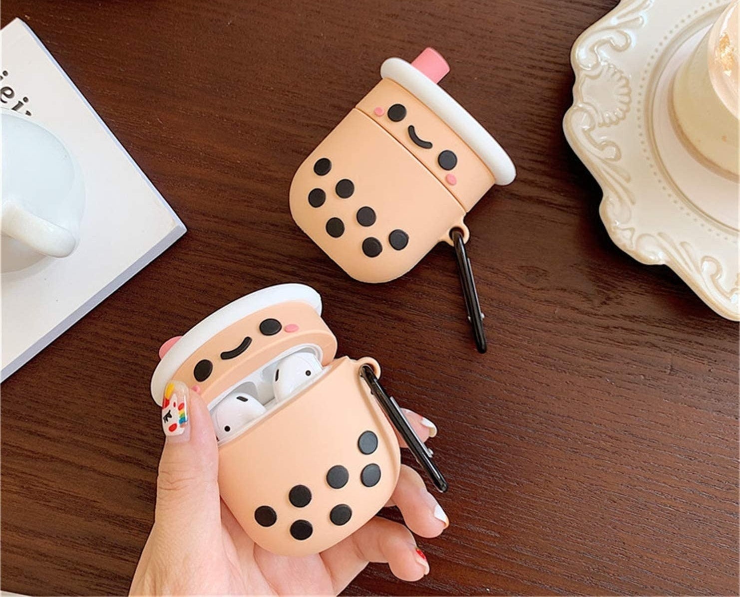 hand holding boba-tea shaped AirPods case