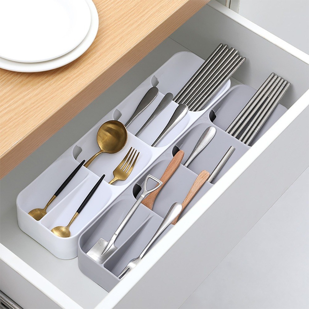 the plastic utensil holder in a drawer with utensils inside