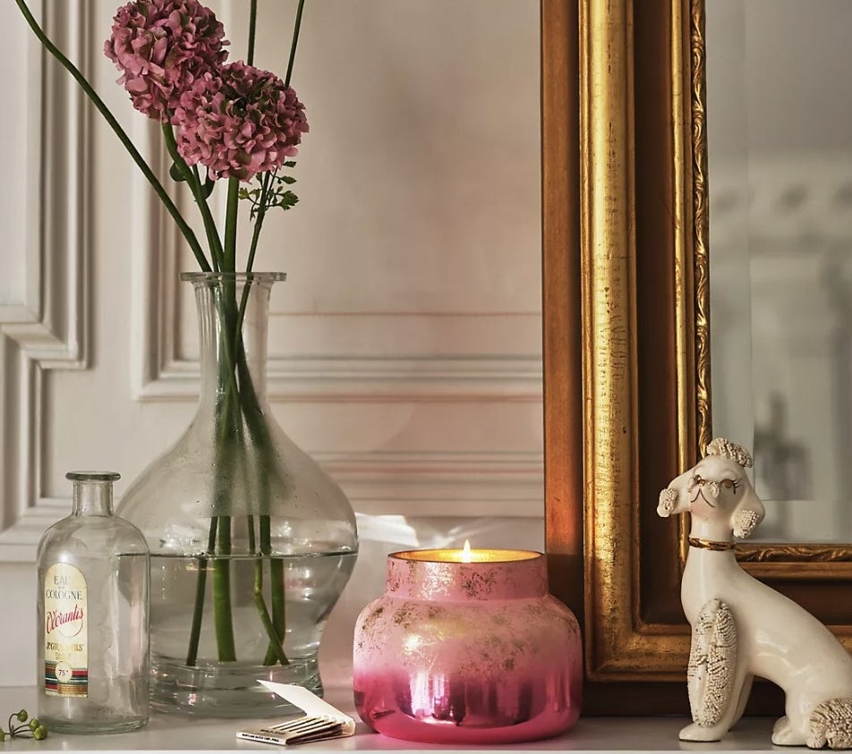The pink candle gently flickering on mantlepiece