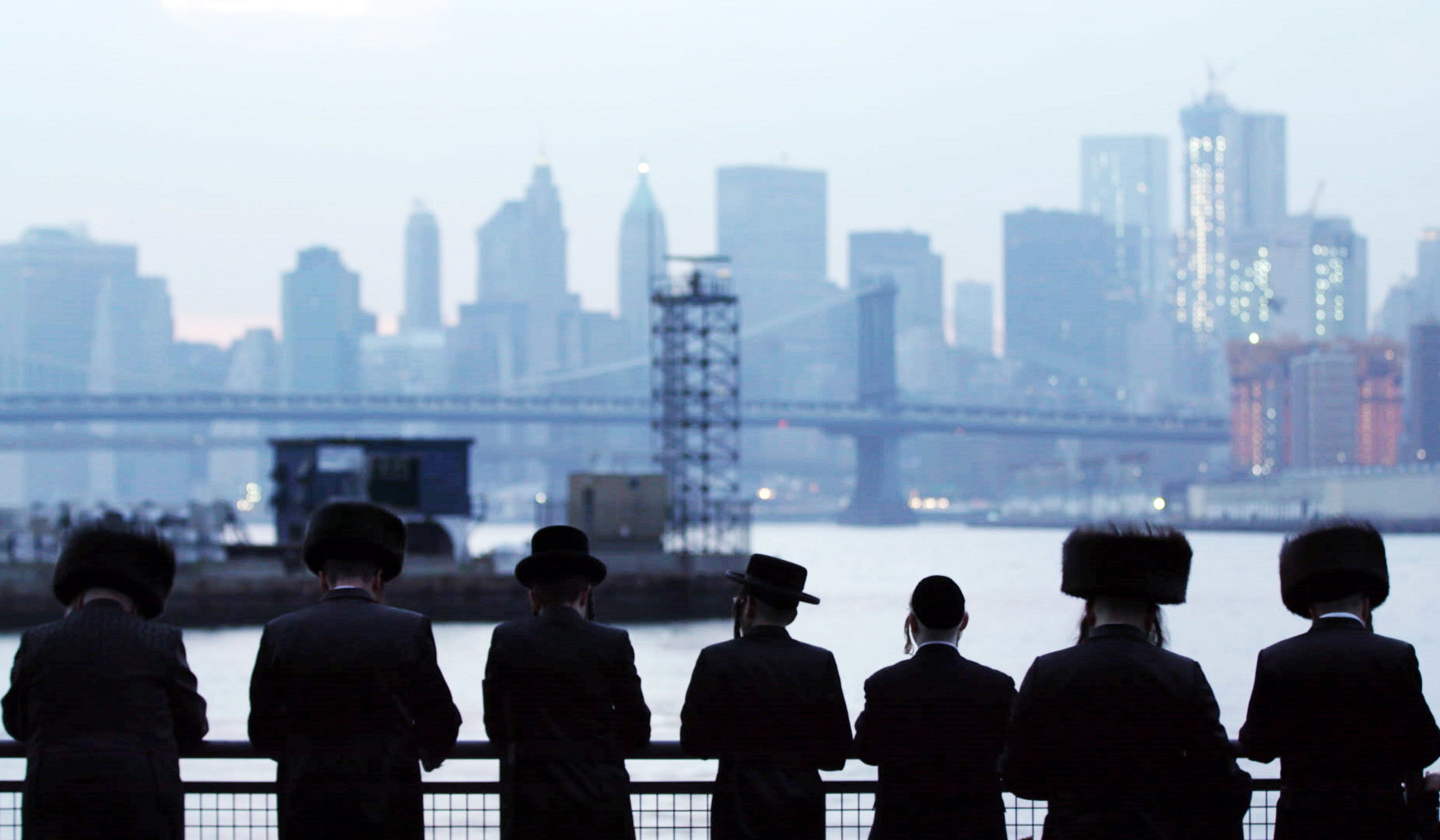 A group of Jewish men look out at New York City&#x27;s skyline