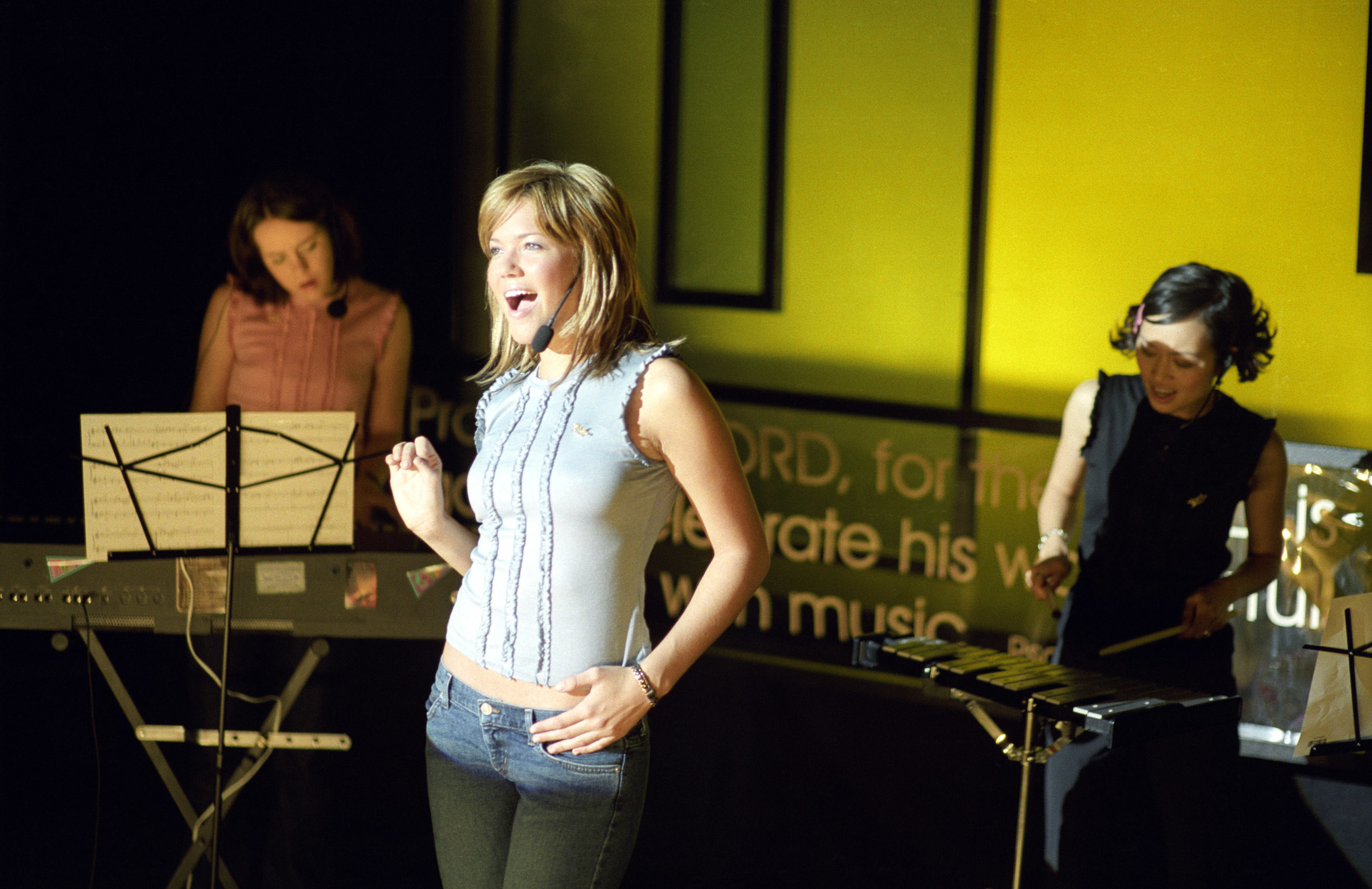 Mandy Moore leads worship at a church with Jena Malone and Elizabeth Thai on instruments