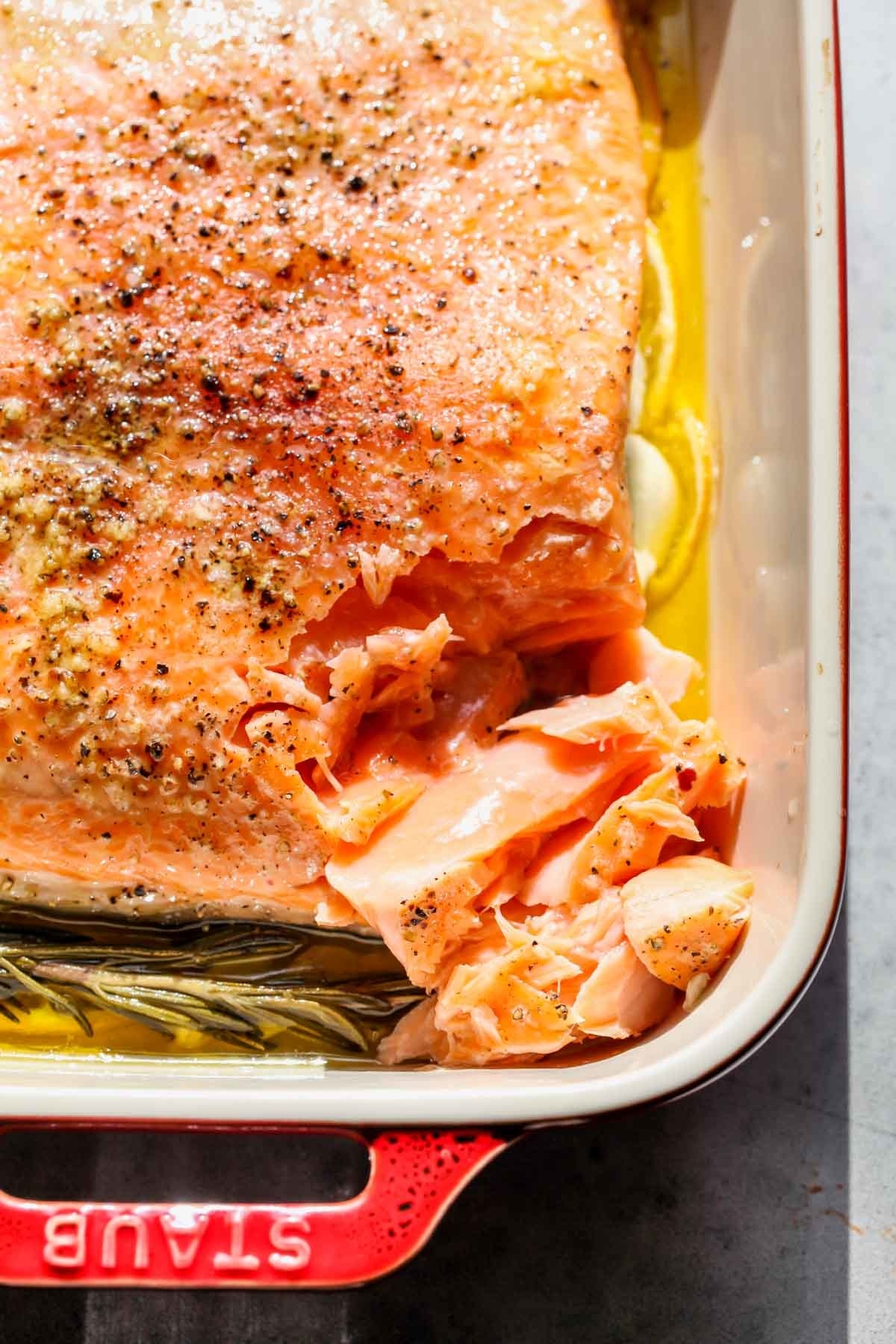 Slow cooked salmon in a baking dish.