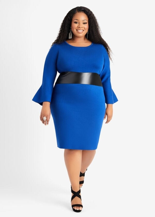 model in blue knit knee-length dress with slight bell sleeves and a faux leather stripe across the waist