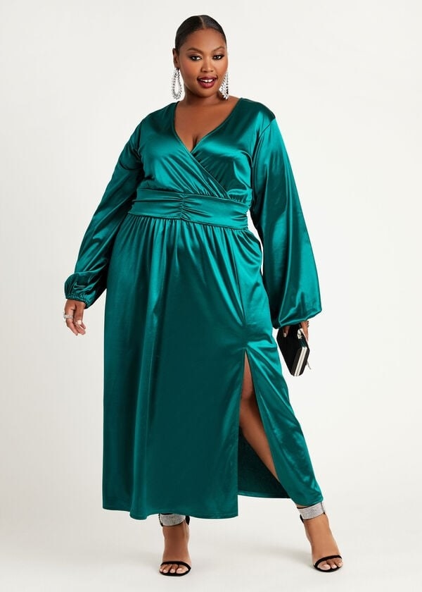 model in green satinmaxi dress with long balloon sleeves, a faux wrap, and one slit