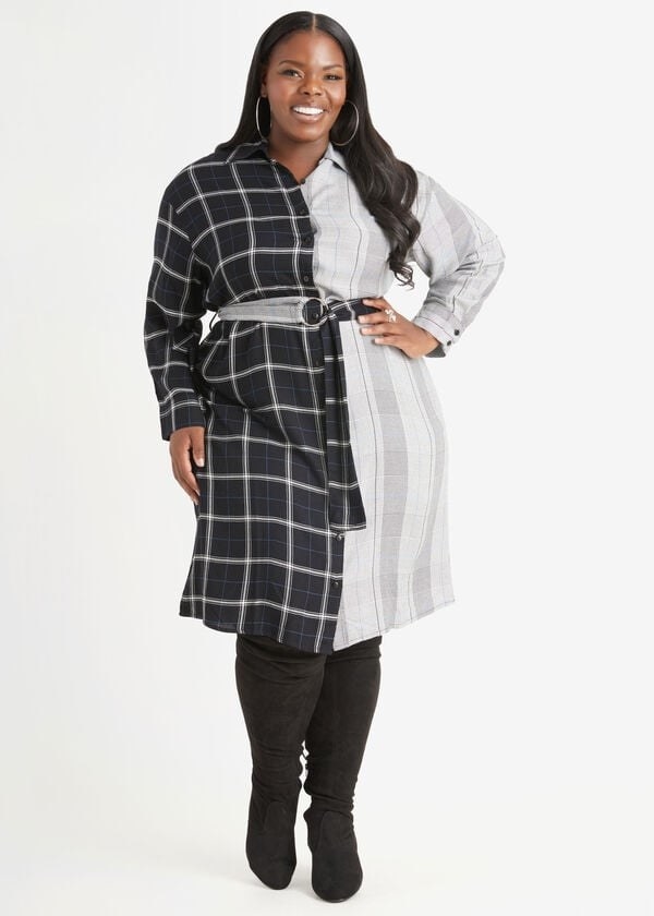 model in a button-up knee-length dress with a belt that&#x27;s half black plaid and half white and grey stripes
