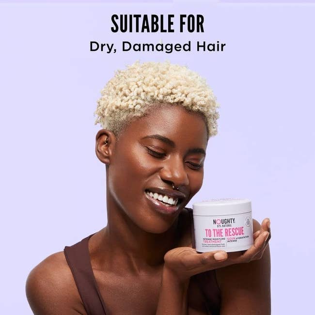 a model holding a jar of noughty to the rescue hair mask