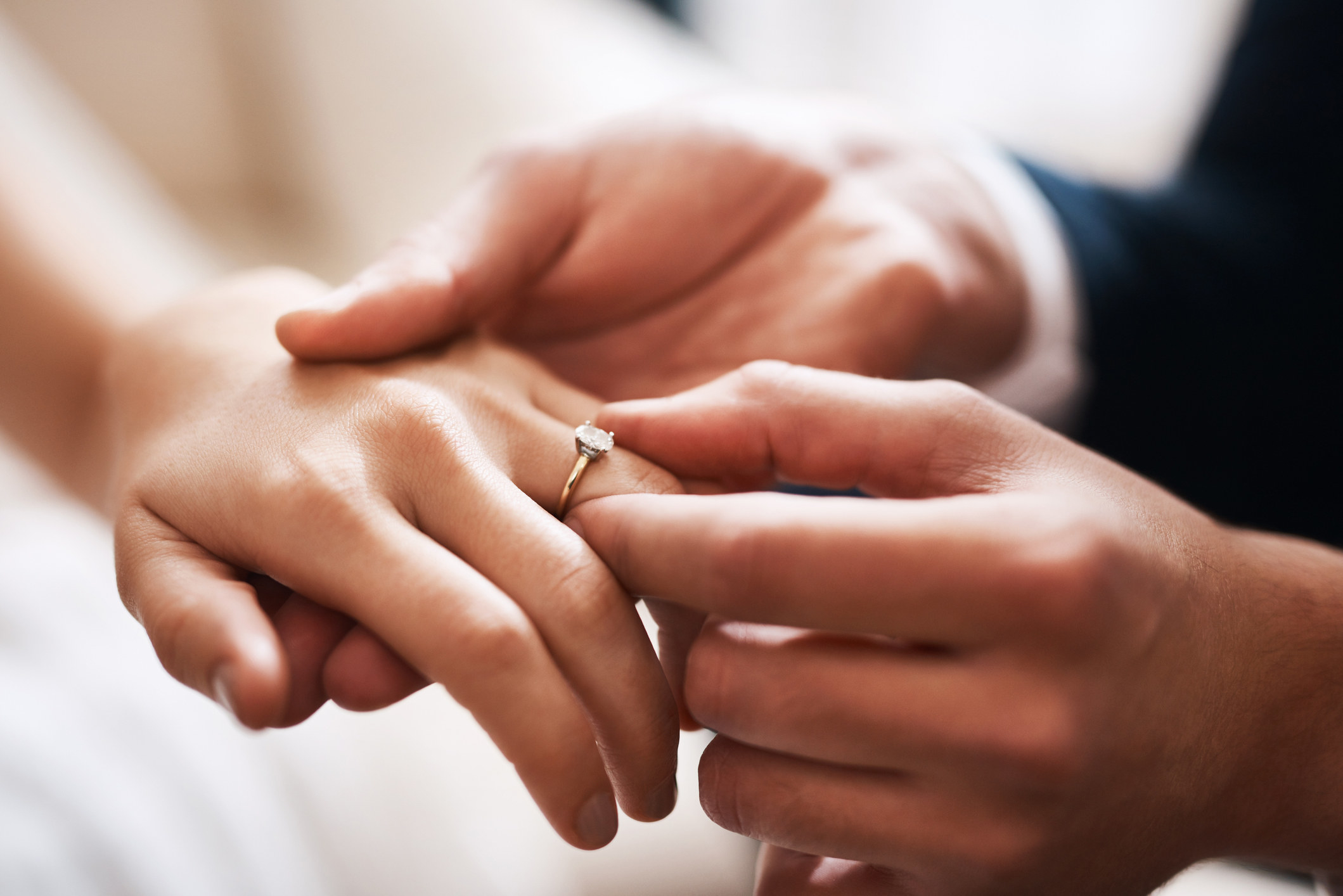 Man puts wedding ring on woman&#x27;s hand