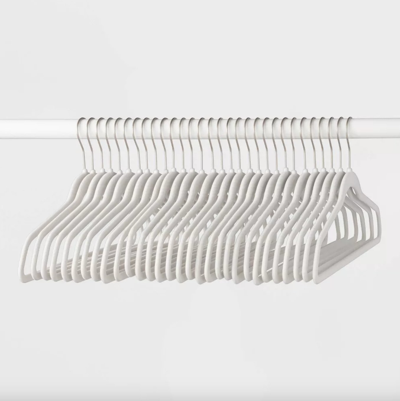 the set of white hangers on a white clothes rod